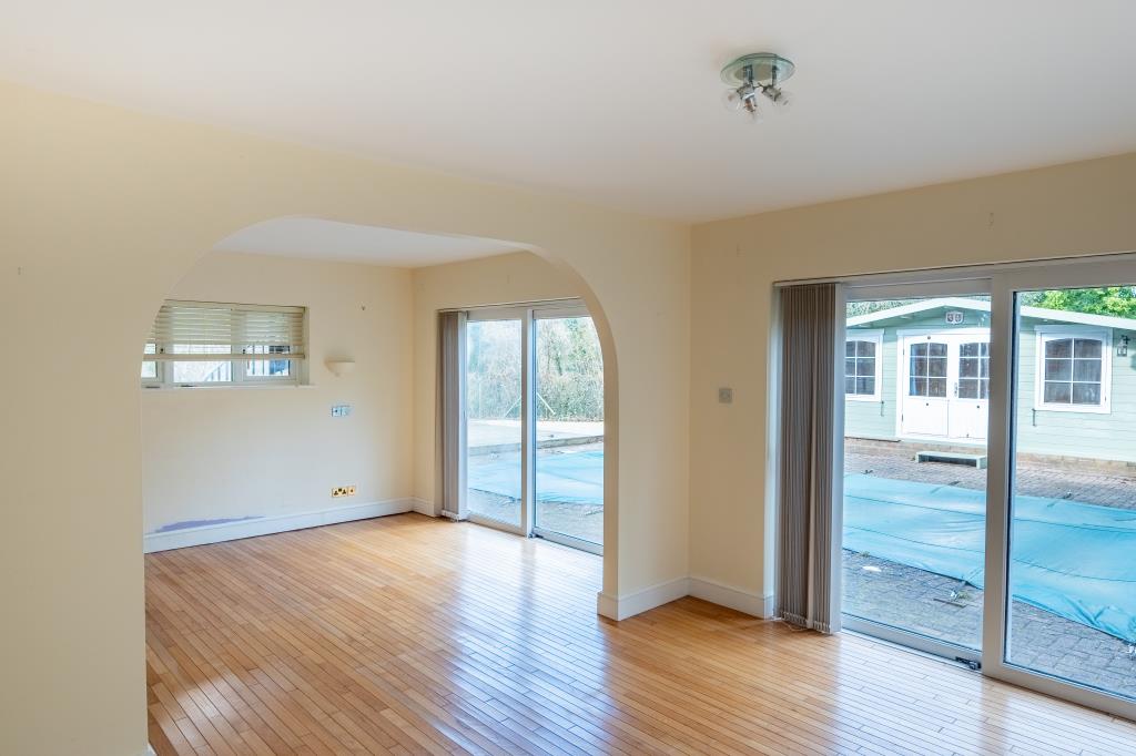 Lot: 164 - THREE-BEDROOM HOUSE IN SECLUDED LOCATION OVERLOOKING WOODLAND - Bedroom One looking out to patio area and swimming pool